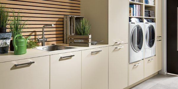 Cream Utility Room with cladding, plants and white goods.