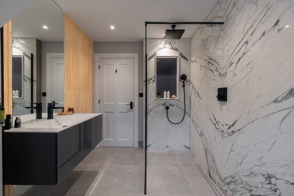 His and her bathroom with marble walls