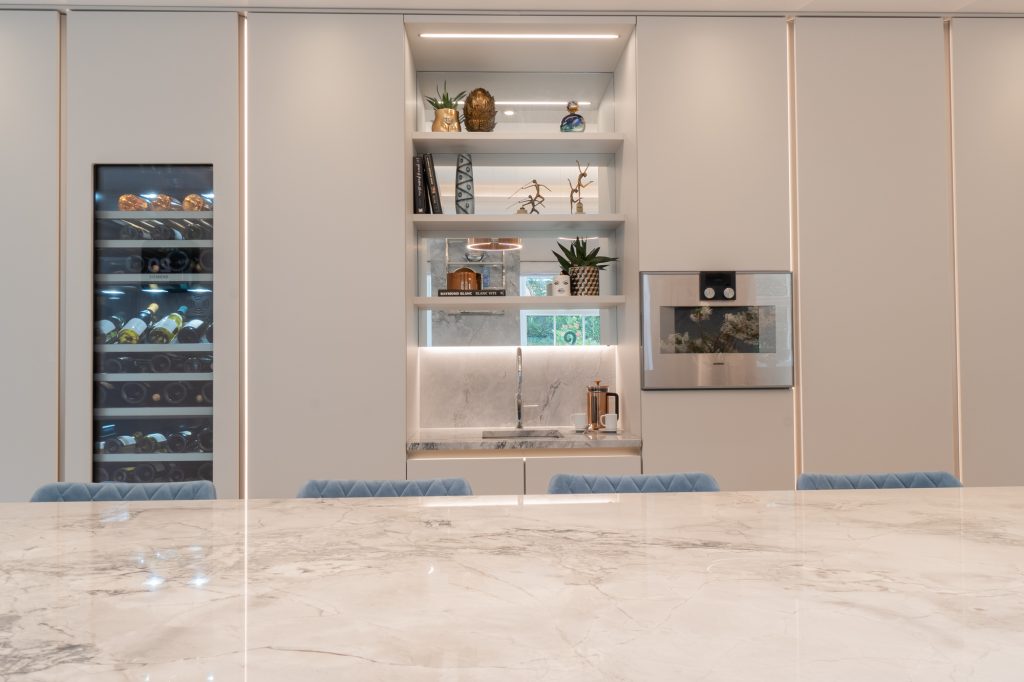 Oxshott Kitchen Cabinets with sink and wine fridge