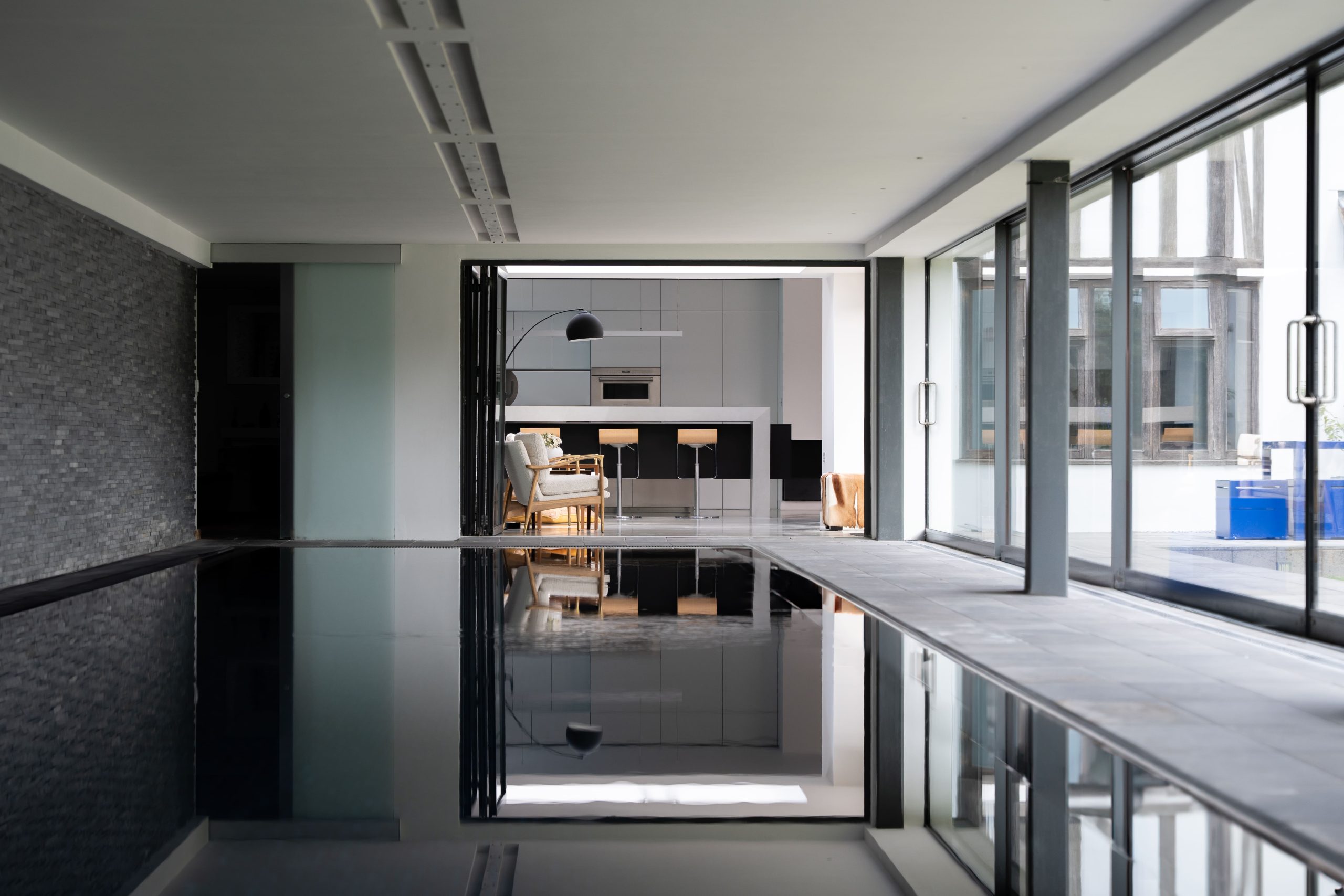 view of the kitchen from a distance with swimming pool in foreground